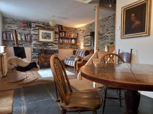 a living room with a wooden table and chairs at Chapel Cottage in Machynlleth