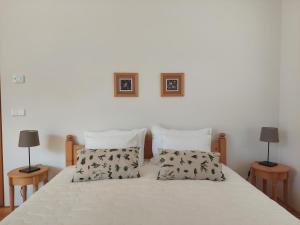 a bedroom with a bed with two lamps on two tables at Apartma Hiša 6 in Bohinj