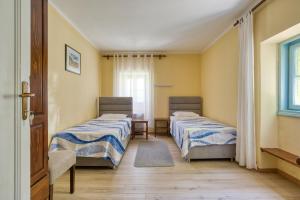 a room with two beds and a window at Kazanegra Exclusive Apartments in Sveti Stefan