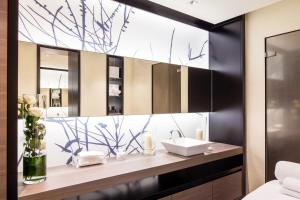 a bathroom with a sink and a mirror at Baglioni Hotel Regina - The Leading Hotels of the World in Rome