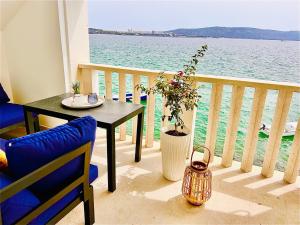 a balcony with a table and a view of the water at Stella Apartments in Kaštela