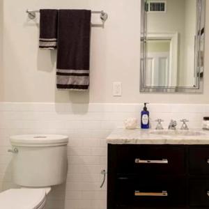 a bathroom with a toilet and a sink and a mirror at Spectacular vacation home with excellent location in New York in New York +15 photos