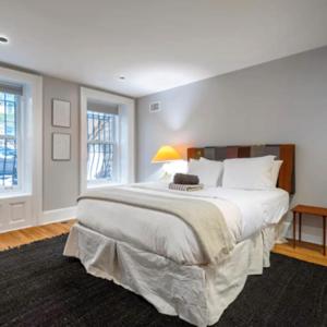 - une grande chambre avec un grand lit et des draps blancs dans l'établissement Spectacular vacation home with excellent location in New York, à New York