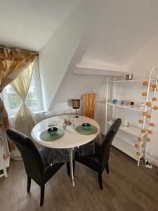 a dining room with a table and chairs at Le cocon jaune - Studio en hyper centre in Lamballe