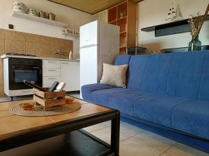 a living room with a blue couch and a table at Apartments Luka in Tisno