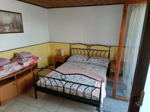 a small bedroom with a bed and a window at Apartments Luka in Tisno