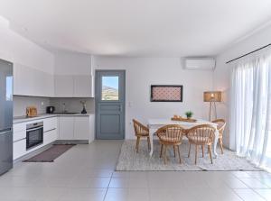 a kitchen and dining room with a table and chairs at Calliope house in Kampos Paros