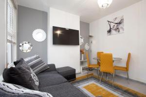 a living room with a couch and a table at Dream Home Estate in London