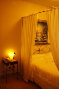 sypialnia z łóżkiem i stołem z lampką w obiekcie Il Paradello Albergo w mieście Porto Levante
