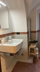 a bathroom with a white sink and a mirror at Blu Bari in Bari