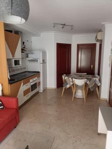 Il comprend un salon avec une table et une cuisine. dans l'établissement Torrox, à Fuengirola