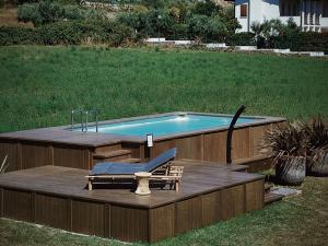 a swimming pool with a deck and a chair and a table at Bed & Breakfast IL PAJO in Padenghe sul Garda