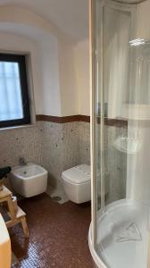 a bathroom with a shower and a toilet and a sink at Blu Bari in Bari