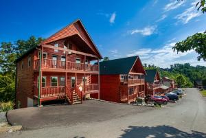 a large log cabin with a parking lot at Bandit Lodge BRAND NEW CABIN w Pool in Sevierville