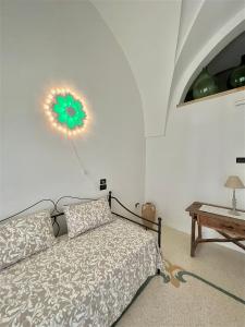 a bedroom with a bed and a clock on the wall at Casa Vacanze Il Pumo in Corsano