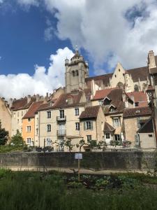 a building with a tower on top of a city at Appartement près de DOLE in Menotey