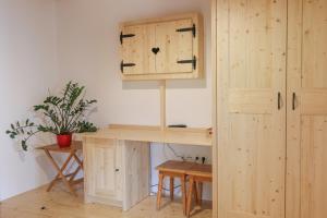 a wooden desk with a cupboard in a room at Tourist farm Mulej in Bled