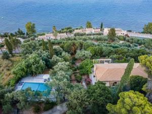 an aerial view of a house with a pool and trees at Villa Scheria in Benitses