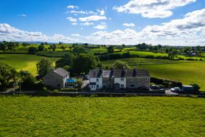 an aerial view of a house in the middle of a field at Pemberton Cottage in Ingleton 