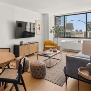 a living room filled with furniture and a large window at Family Apartment in Excellent Sector of New York in New York