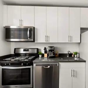 a kitchen with a stove and a microwave at Family Apartment in Excellent Sector of New York in New York