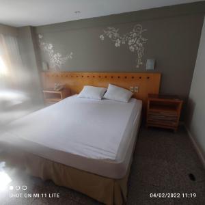 a bedroom with a large bed with white sheets at BEIRA MAR MEIRELES in Fortaleza +22 photos