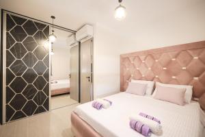 a bedroom with a large bed with two towels on it at Apartmani Bliss in Sukošan +30 photos