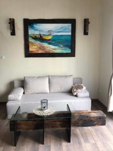 a living room with a couch and a coffee table at Zatoka Marina in Mechelinki