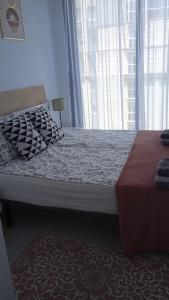 a bedroom with a bed and a large window at Sea view and Ifach Calpe in Calpe