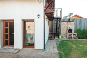 a white house with a wooden door and a yard at Casa Sara in Turda +11 photos