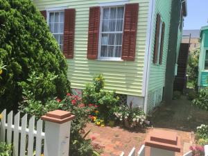 a house with a white fence and flowers at Studio apartment at Historical House in Galveston