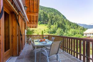 einen Tisch und Stühle auf dem Balkon eines Hauses in der Unterkunft La Grange de St Même in Saint-Même