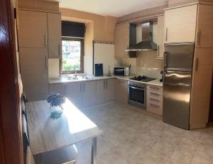 a kitchen with stainless steel appliances and a counter top at Casa A Illa de Arousa in Isla de Arosa