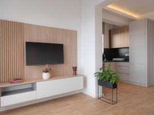 a living room with a television on a wall at Lovely Partial Sea View one bedroom flat in Horizon Residences A22 in Becici