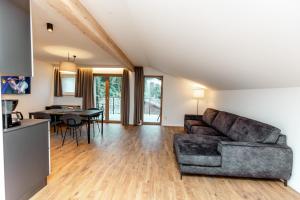 a living room with a couch and a table at Tyrol Living & Cafe in Nova Levante