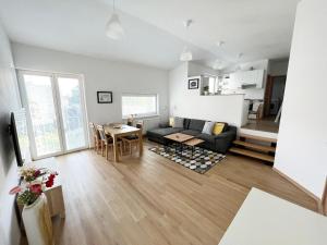 a living room with a couch and a table at Old Town Piešťany Apartments in Piešťany