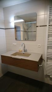 a bathroom with a sink and a mirror at Ferienwohnung Höllwarth in Gerlos