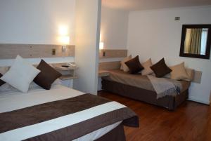 Cama o camas de una habitación en Apart Hotel Cambiaso