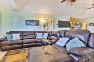 a living room with a brown leather couch at Escape From The Storm in Bolivar Peninsula