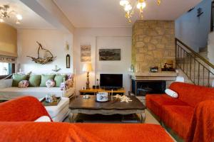 a living room with a couch and a fireplace at Villa Pino Pueblo in Paliouri