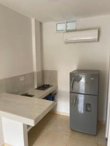a kitchen with a stainless steel refrigerator and a counter at Manglearena in Tolú