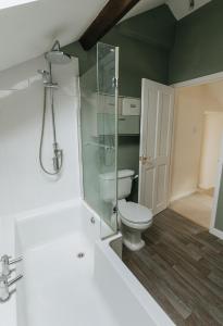 a bathroom with a toilet and a glass shower at ELM HOUSE COTTAGE - 2 Bed Cottage in High Hesket on the edge of the Lake District, Cumbria in High Hesket