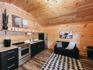 a kitchen with a stove and a sink in a cabin at Cabin 2 One Bedroom W Kitchen in Hartwell