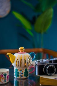 a tea pot and a camera on a table at Merry Land Hotel Da Nang in Danang