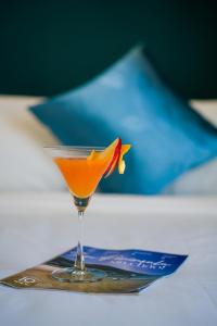 a drink in a martini glass on a tray at Merry Land Hotel Da Nang in Danang