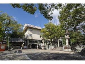 a building with a clock tower in front of it at Seto Park Hotel - Vacation STAY 83745v in Seto