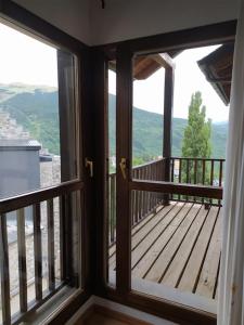 balcón con 2 ventanas y vistas a las montañas en CHECK-IN CASAS Apto Cercedilla, en Cerler