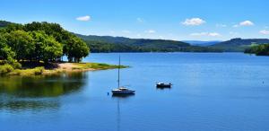 two boats sitting on a large body of water at Chez Daniel in Vauclaix