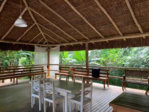a patio with a table and chairs on a deck at excelente casa em Juquehy in São Sebastião