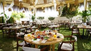 a table with food on it in a restaurant at Albeon Luxury Hotel - Alacatı in Alaçatı